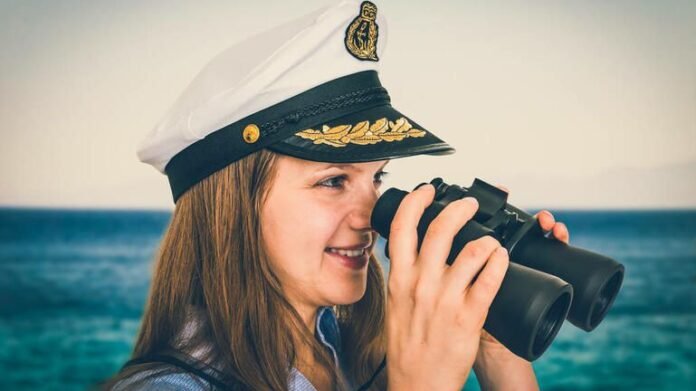 stock-photo-happy-female-captain-holding-binoculars